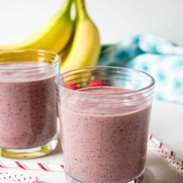 Two glass with a red colored smoothie.