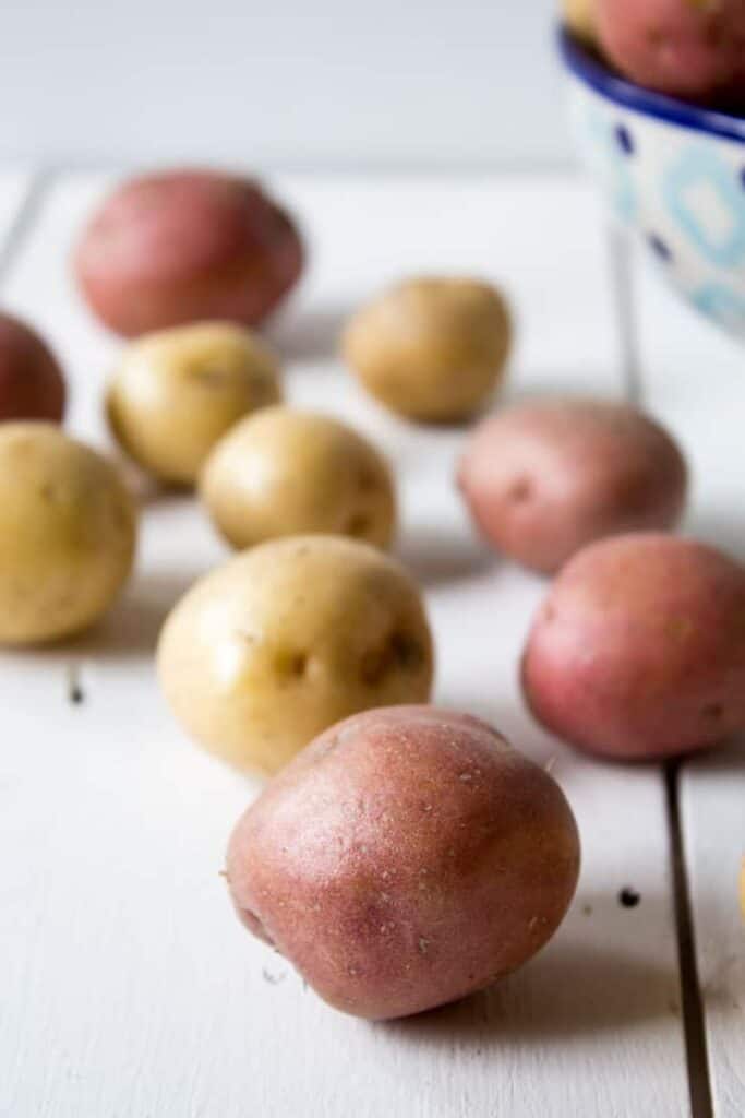 Baby new potatoes on a white board.