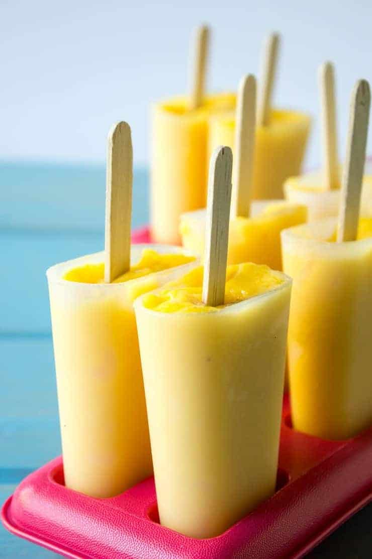Peaches and Manoes pureed and poured into popsicles molds. Once these freeze, they make a delicious and healthy snack!
