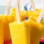 Bright yellow popsicles with wooden sticks.