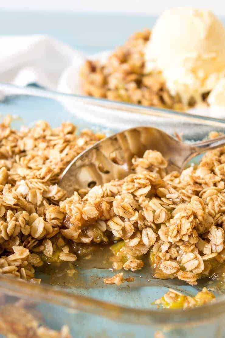 Rhubarb crisp with an oatmeal topping in a glass dish.