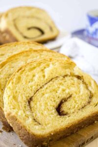 Slices of cinnamon bread on a wooden board.