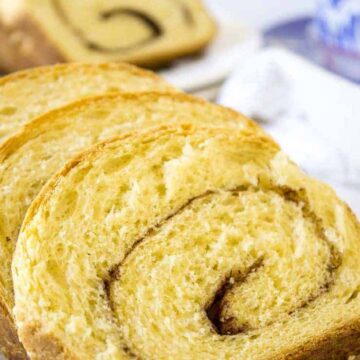 Slices of cinnamon bread on a wooden board.