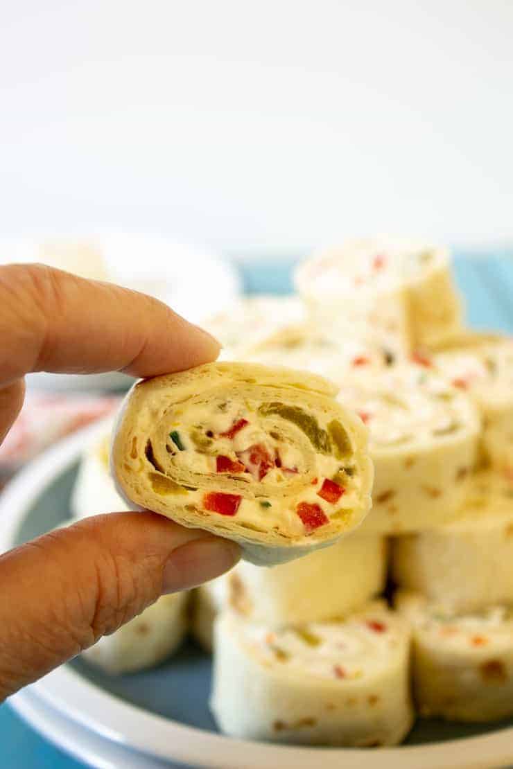 A closeup of a tortilla appetizer with a plateful in the background. 