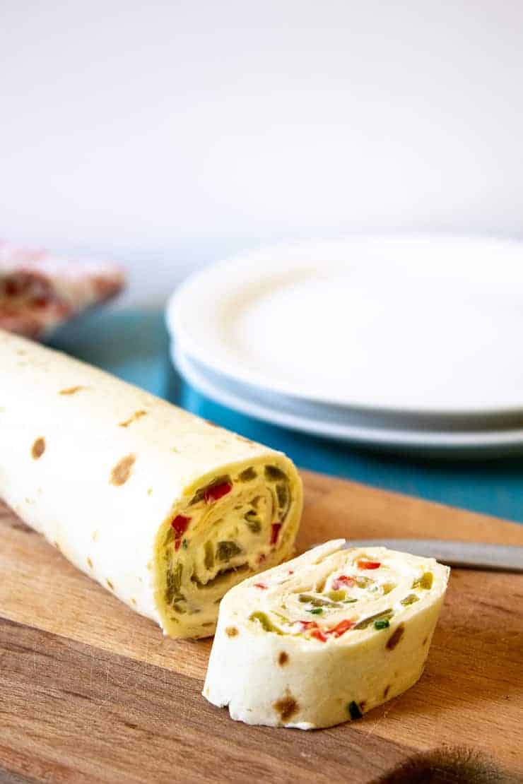 Slicing up a roll of Mexican Tortilla Pinwheels.