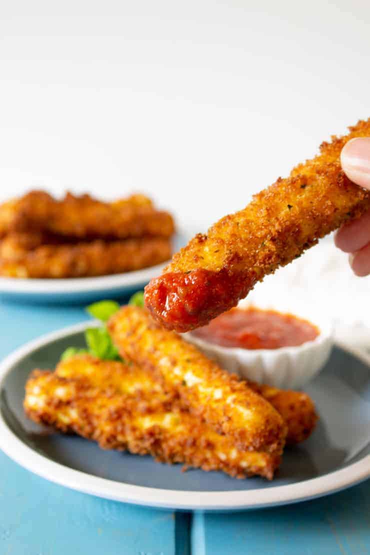 Mozzarella cheese sticks dipped in marinara sauce