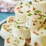 Cream cheese pinwheels on a blue and white plate.