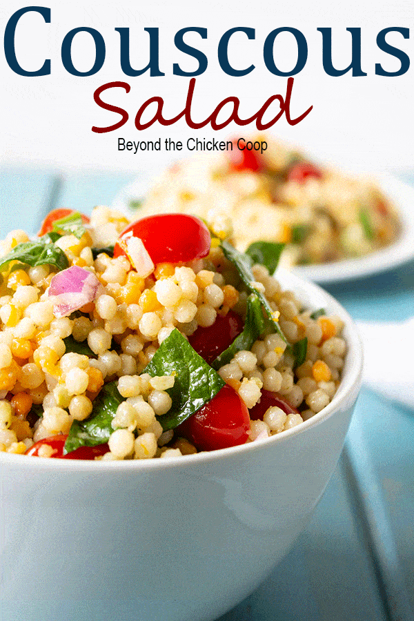 Fresh spinach, tomatoes, and Israeli couscous topped with an orange vinaigrette. This salad is perfect for potlucks, picnics and BBQs. #summertime #couscous #coucoussalad #spinach