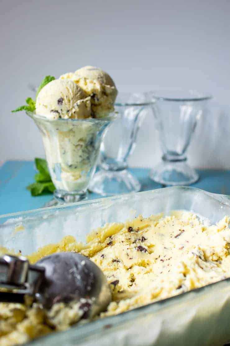 Scooping up ice cream from a glass dish.