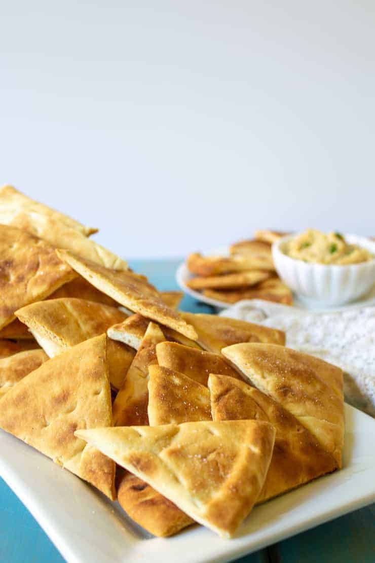 Freshly made chips on a white platter.