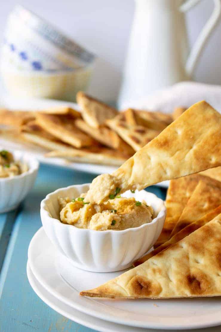 Quick pita chips with a dip of garlic hummus.