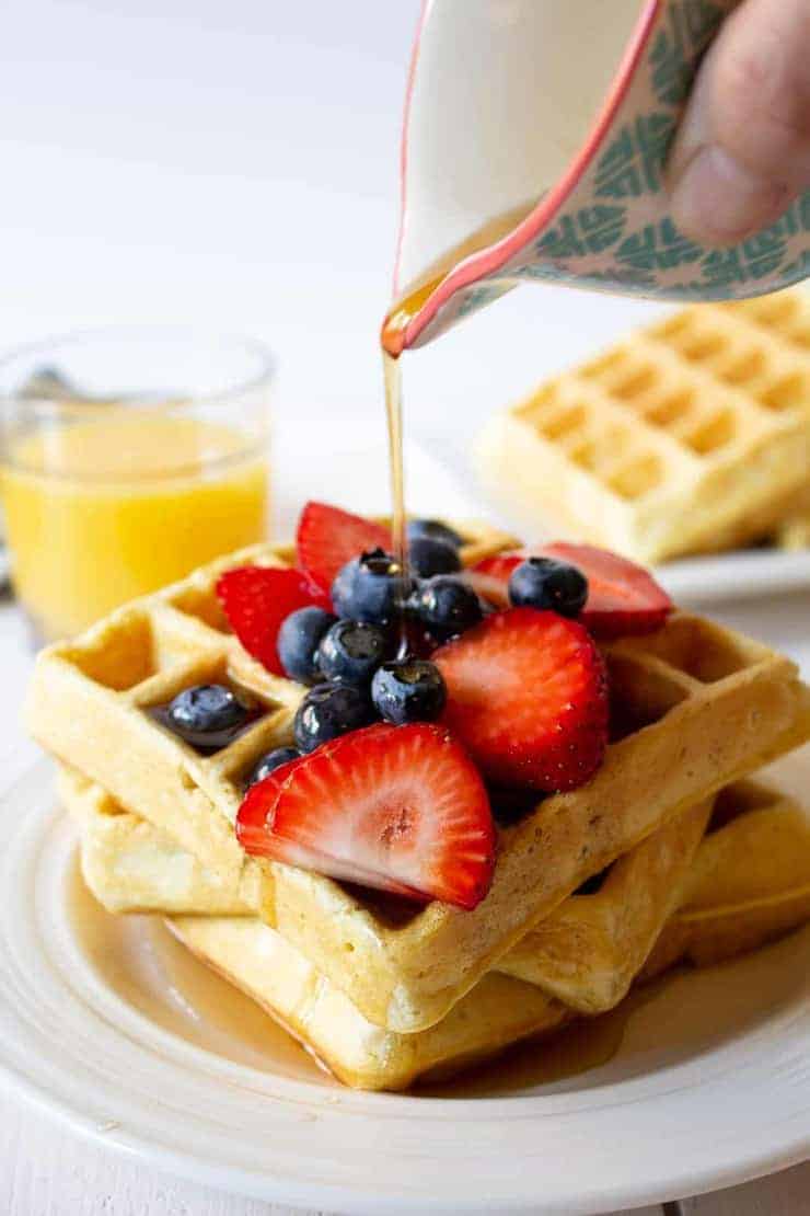 Waffles with fresh fruit and syrup.