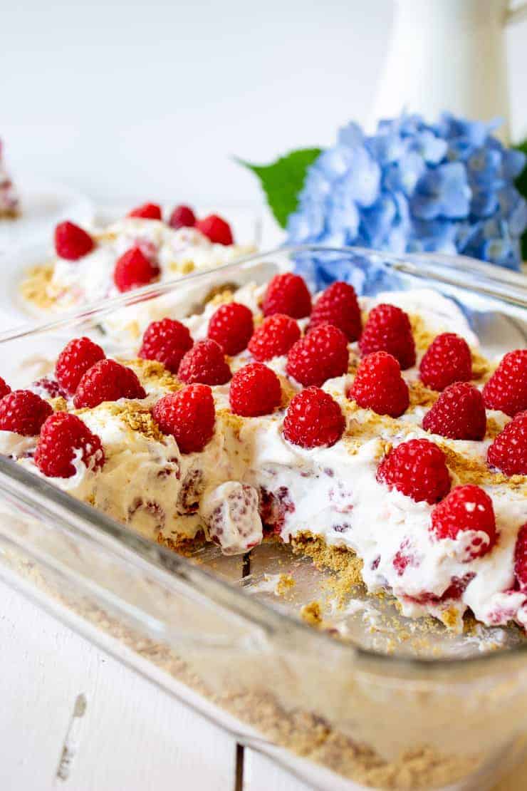 Half of a glass baking dish filled with raspberry delight.