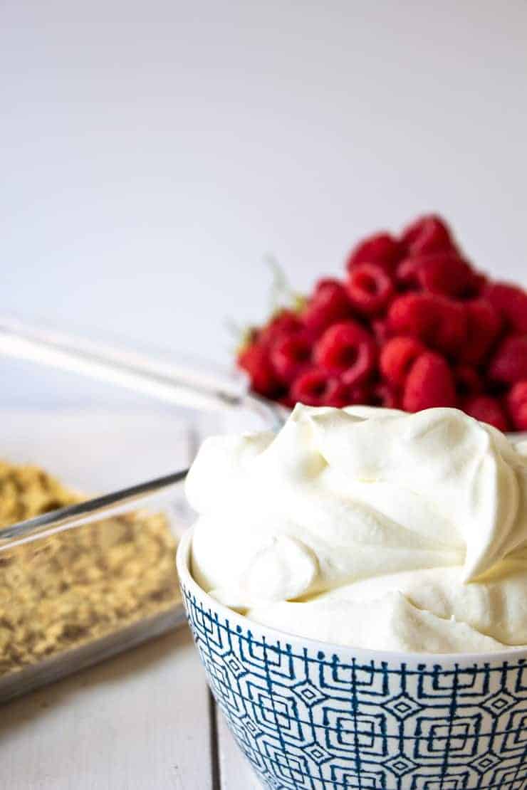 Fresh whipped cream in a blue and white patterned bowl.