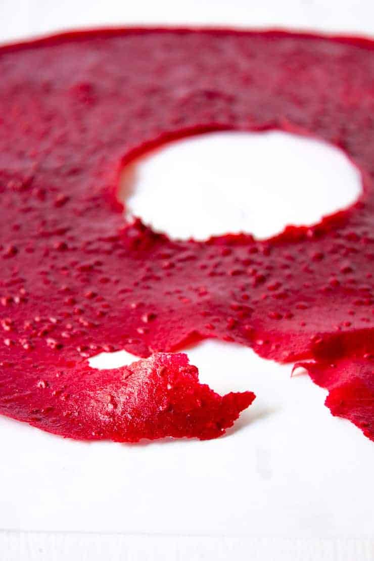 Raspberry Fruit leather with a tear on one end. 