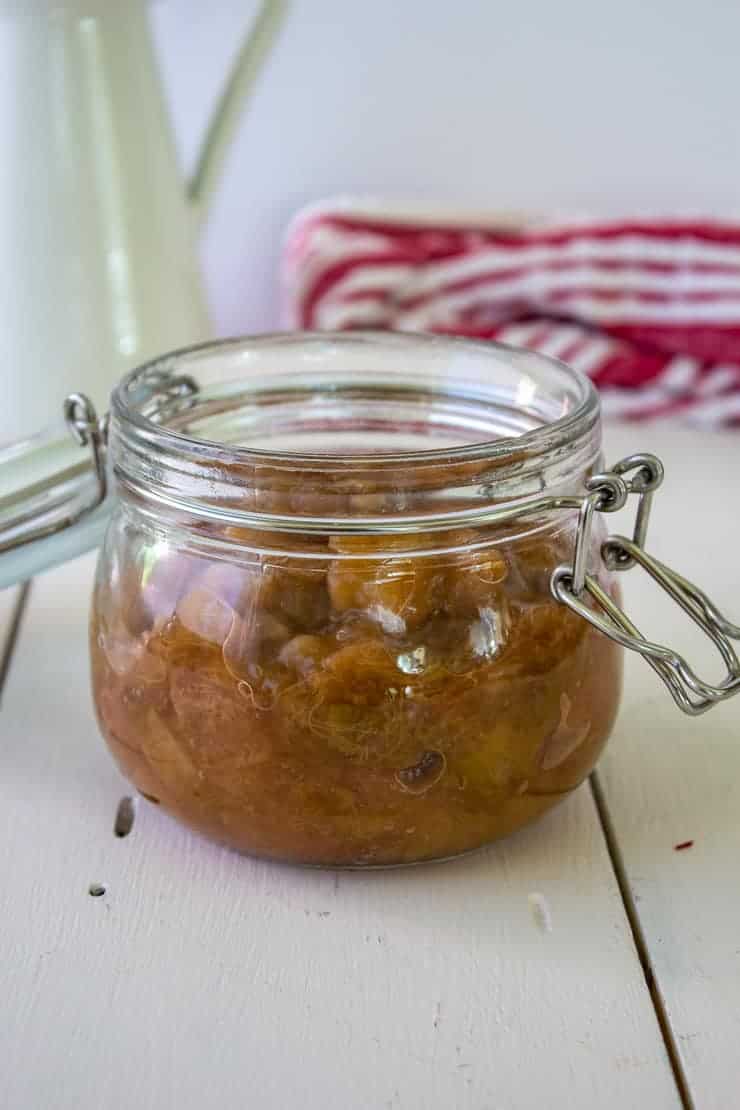 Homemade rhubarb sauce in a small glass crock.