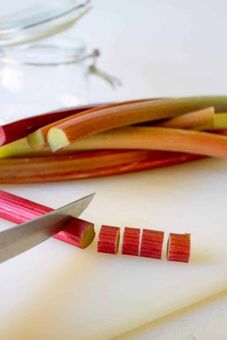 Fresh cut rhubarb on a cutting board.