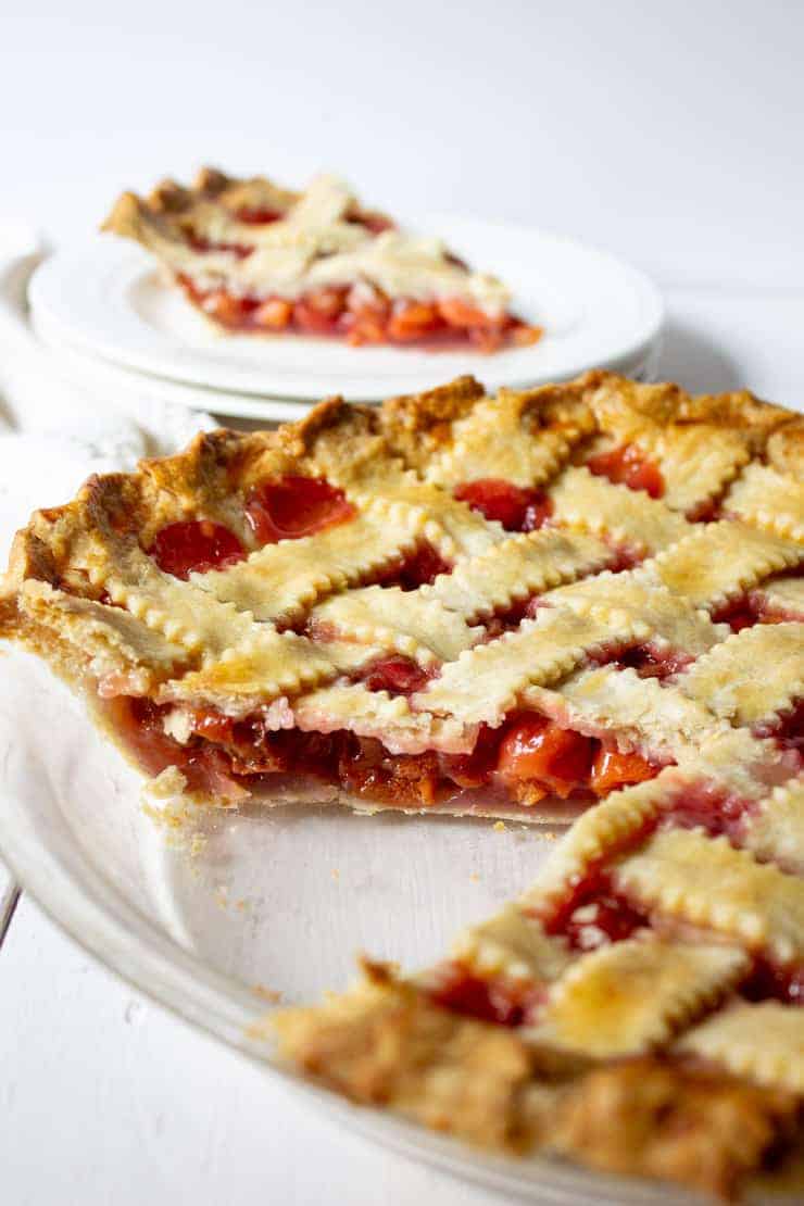 Homemade Cherry Pie with a lattice topping and a slice out of the pie.