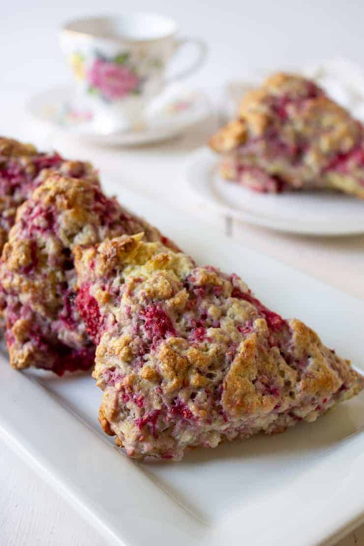 A plateful of scones filled with raspberries.