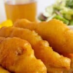 Strips of crispy battered fish on a blue and white plate.