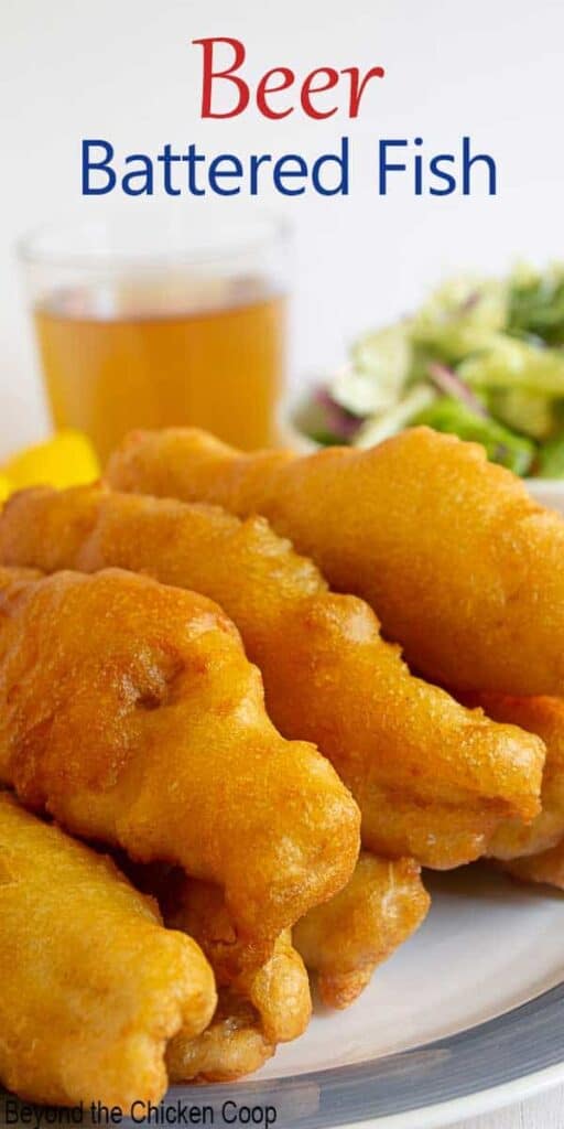 Strips of crispy battered fish on a blue and white plate.