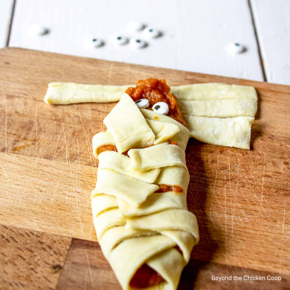 Folding pastry around pumpkin filling.