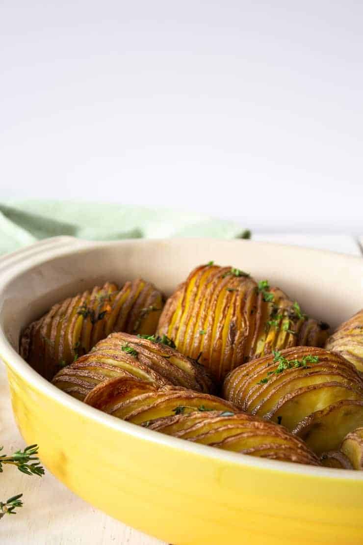 A yellow casserole dish with freshly baked crispy potatoes.
