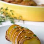 Roasted Hasselback potatoes with a sprinkle of coarse salt and fresh herbs.