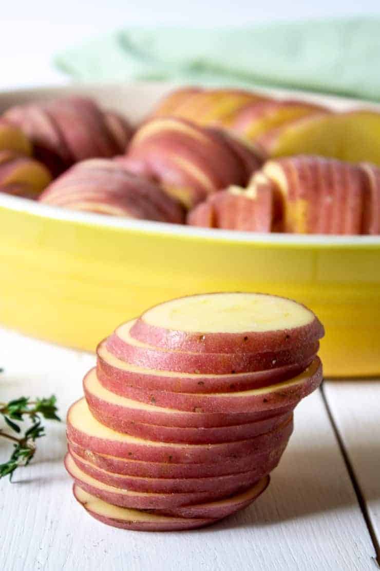 A stack of sliced red potato.