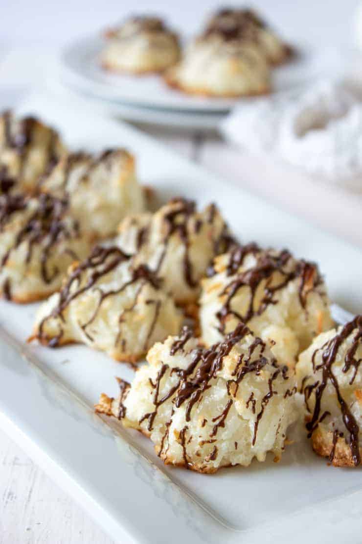 A tray full of Coconut Macaroons drizzled with chocolate.