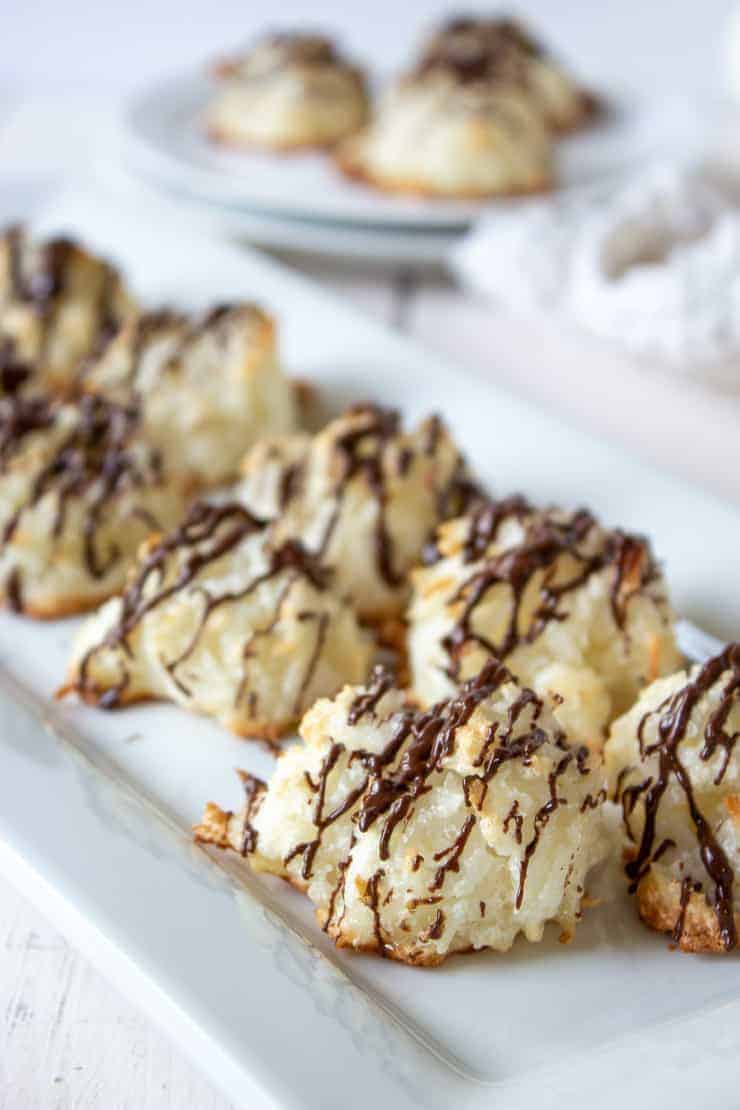 A tray full of Coconut Macaroons drizzled with chocolate.