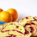 Slice cranberry bread on a white plate.