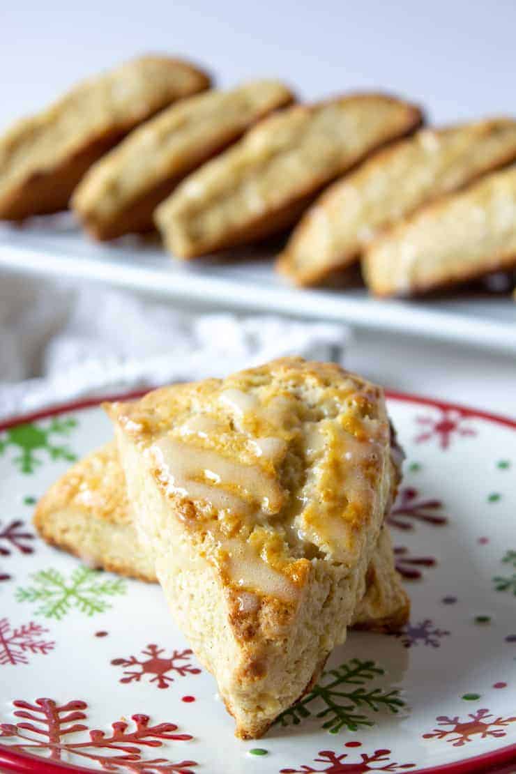 Two triangle shaped scones on a snowflake patterned plate.