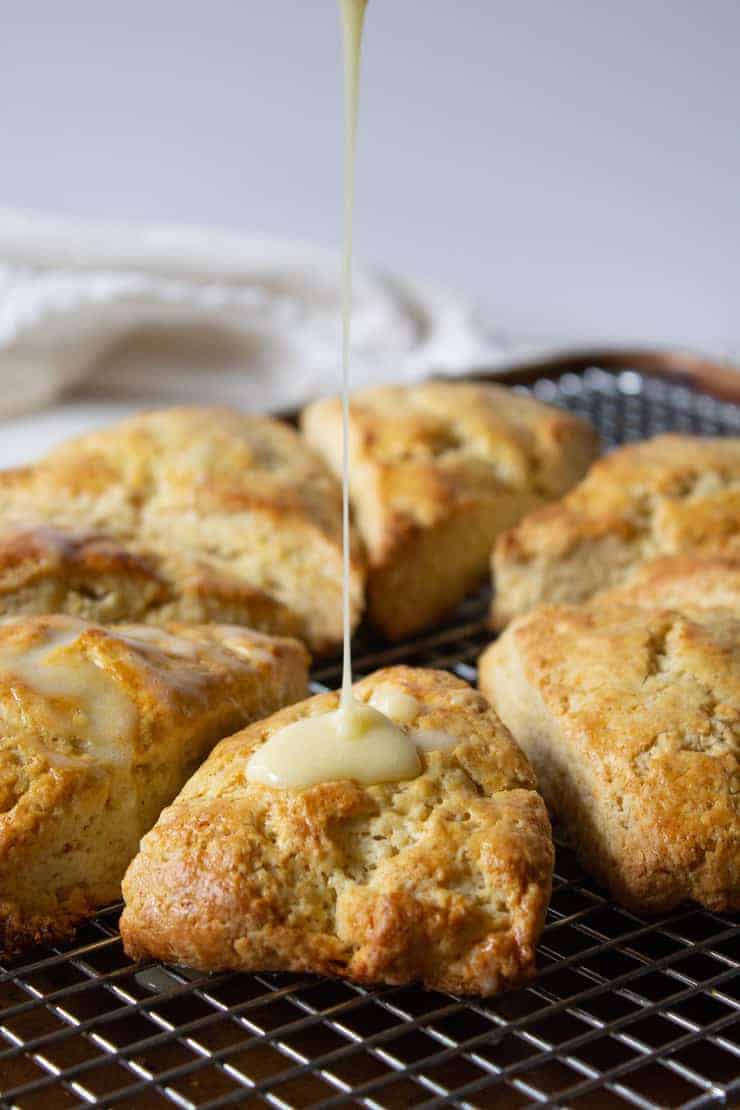 A drizzle onto a scone on a baking rack.