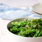 A bowlful of sauteed sugar snap peas.