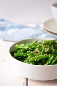 A bowlful of sauteed sugar snap peas.