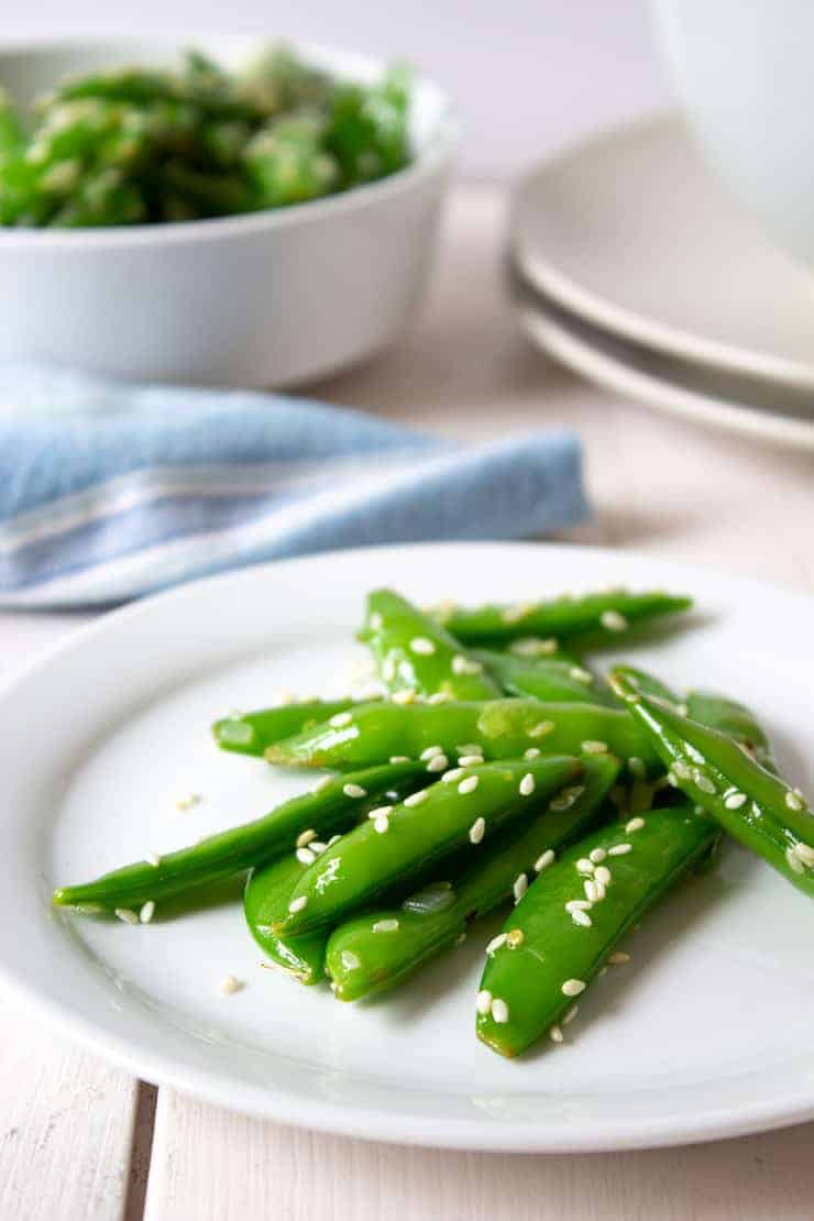 Sauteed Sugar Snap Peas on a small white plate.