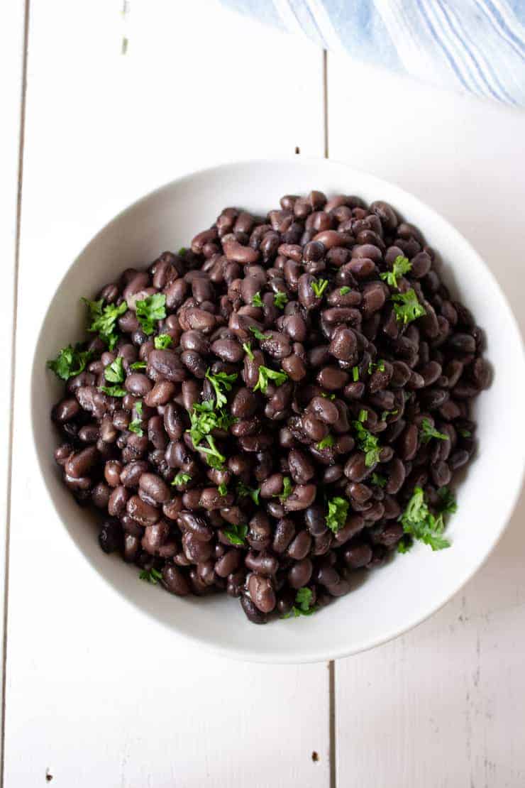 A bowlful of black beans cooked in a pressure cooker.