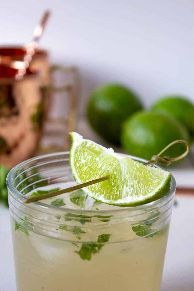 A Moscow Mule in a glass with a lime wedge on top.