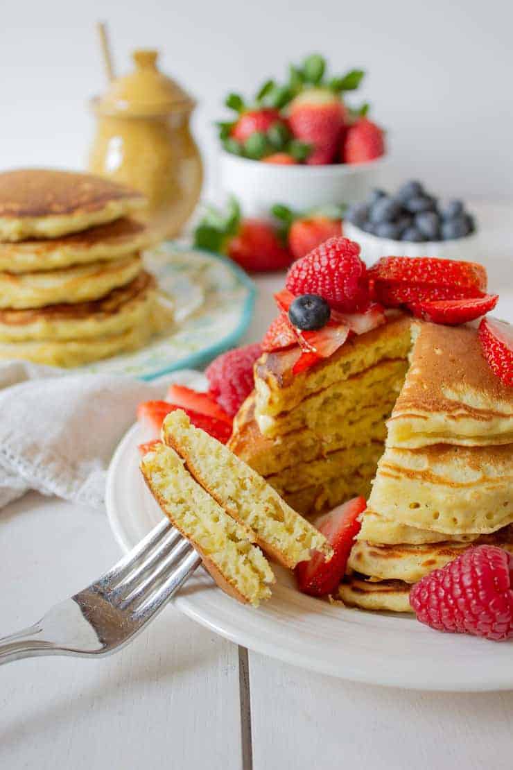 A forkful of pancakes with fresh berries.