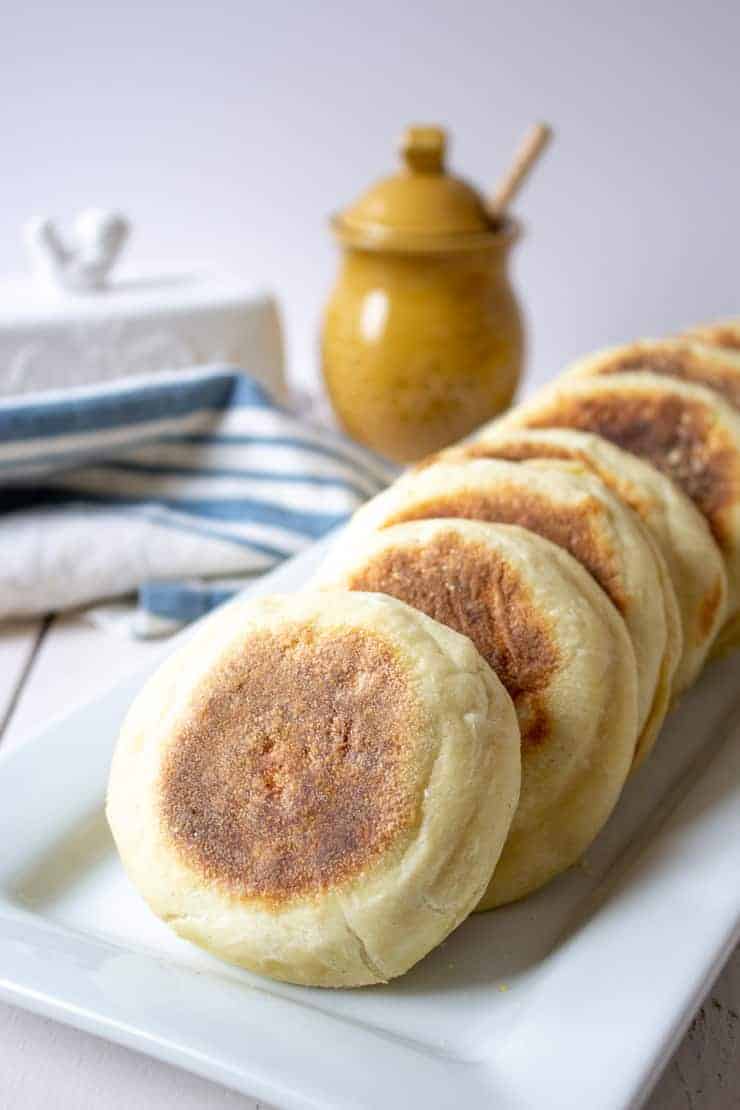 A platter full of homemade sourdough English Muffins.