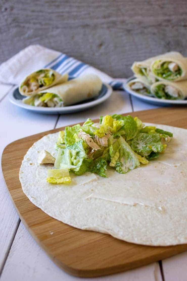 Assembling a chicken caesar wrap