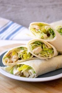 Chicken Caesar Wraps piled on a small blue and white plate.