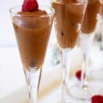 Chocolate mousse topped with fresh raspberries.