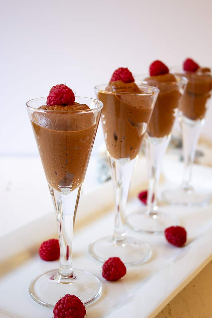 Chocolate Mousse in small glasses topped with a raspberry