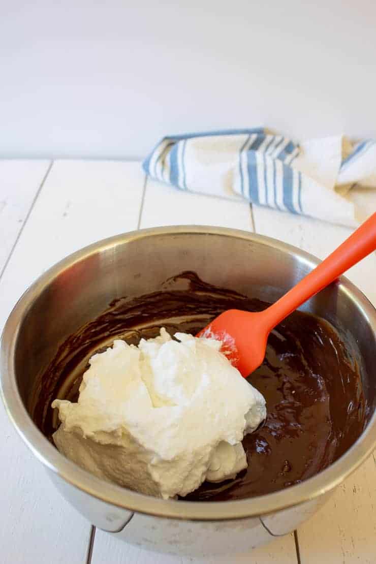 Adding second half of egg whites to chocolate mixture.
