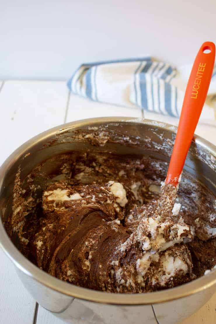 Folding whipped cream into chocolate for chocolate mousse.