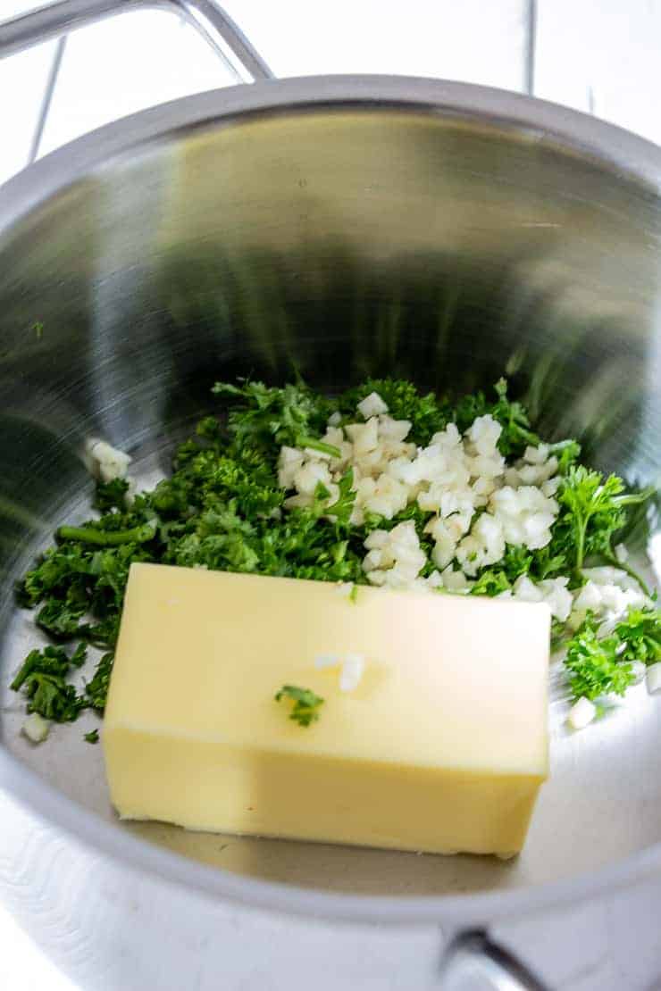 Butter, garlic and parsley for making garlic croutons.