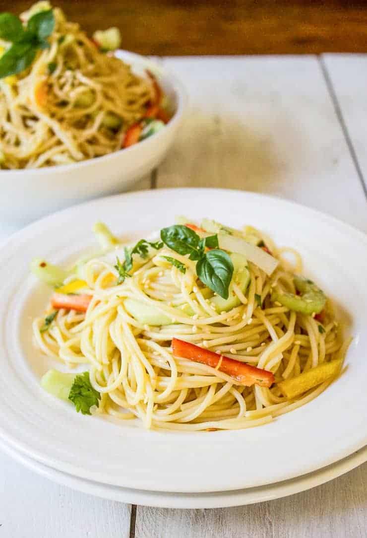 A plateful of pasta with fresh veggies.