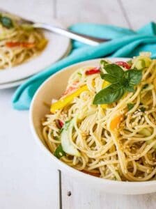 Thai Pasta Salad topped with a fresh sprig of basil